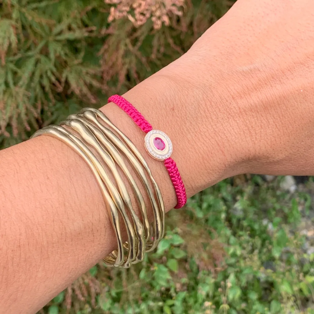 Ruby and Diamond braided bracelet in 10k yellow gold.