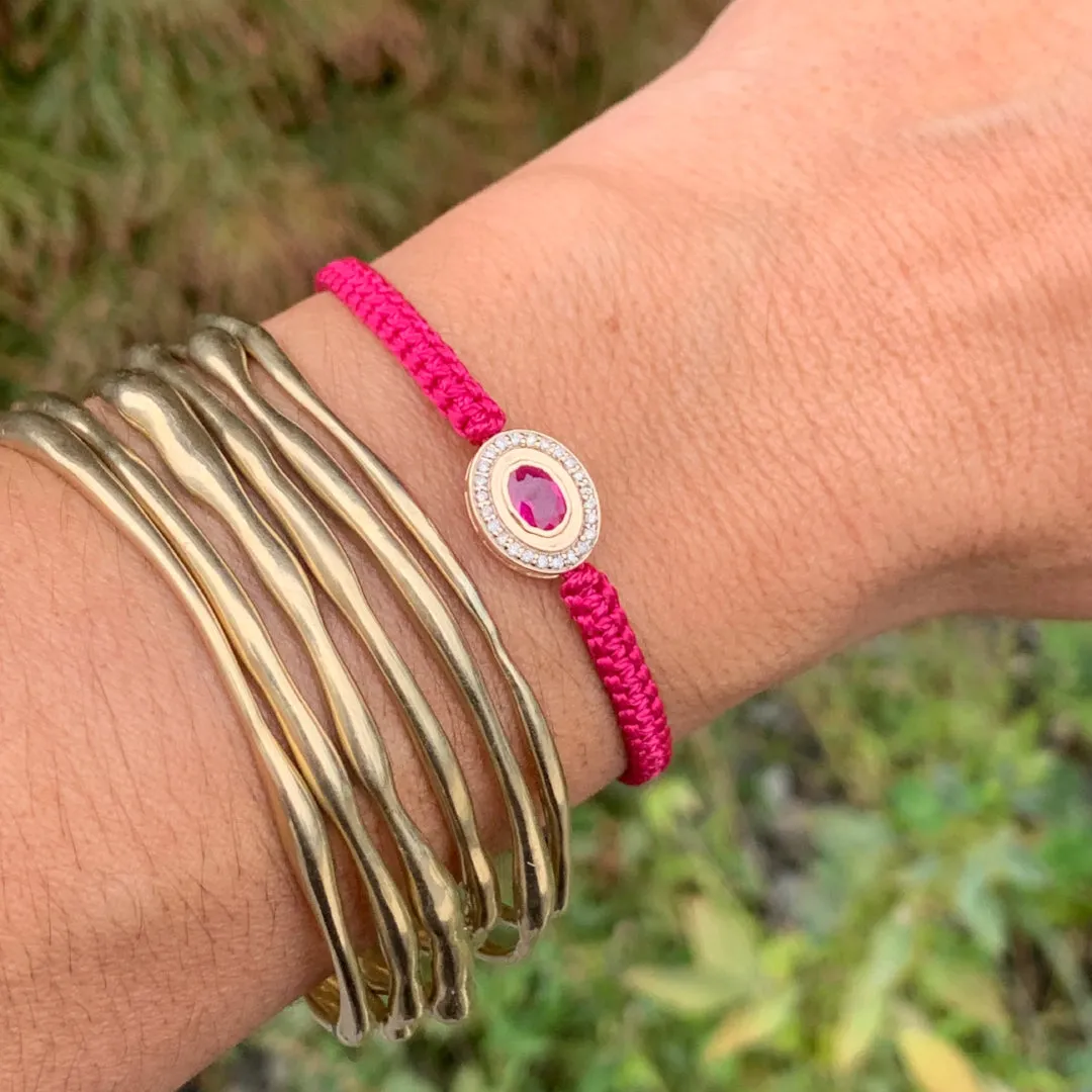 Ruby and Diamond braided bracelet in 10k yellow gold.